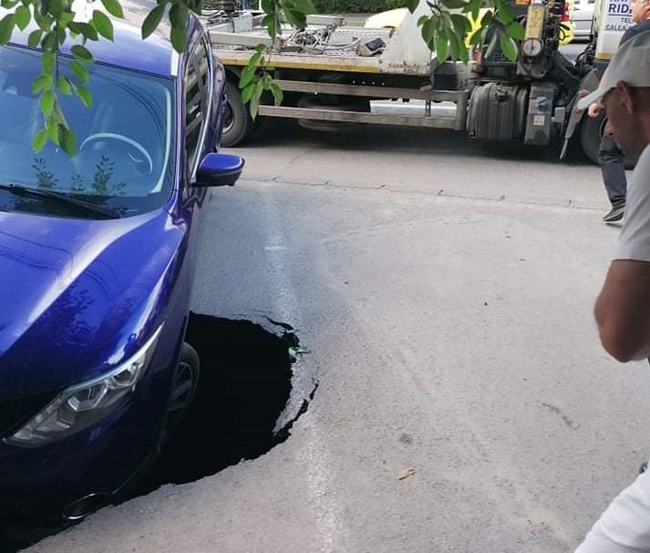 Asfaltul dintr-o parcare din Craiova s-a surpat sub greutatea unui autoturism. Canalizarea a cedat, din cauza ploilor (VIDEO)